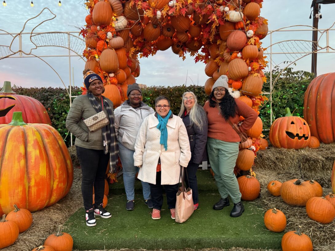 Group of advisors in front of pumpkins